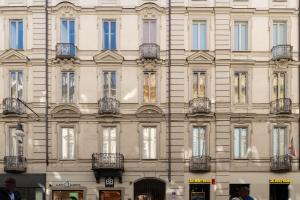 a large white building with many windows at Sweet home in Turin
