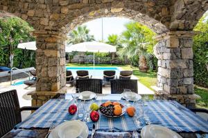 an outdoor table with a bowl of fruit on it at Villa Tara in Ovacik
