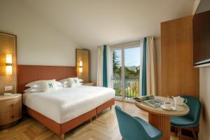 a hotel room with a bed and a table and a window at Villa Miliani in Fabriano +73 photos