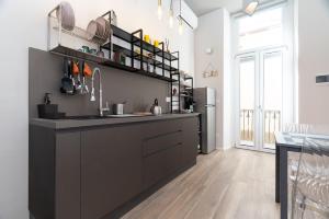 a kitchen with a sink and a refrigerator at Sweet home in Turin