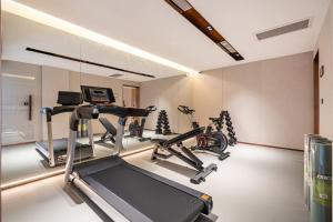 a gym with two exercise bikes and a treadmill at Elong Hotel Beijing Chang'an Tianjie Bridge Huiying Metro Station Branch in Beijing
