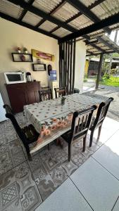 a table and chairs in a room with a table and a table and chairs at Pousada Costeira Barra do Sul in Balneario Barra do Sul