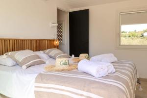 a large bed with towels on top of it at Casetta Mare di Cala Rossa in Cala Rossa
