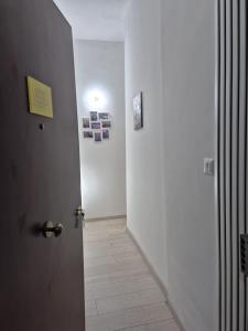 a hallway with a door with a light on it at House Mari in Catania