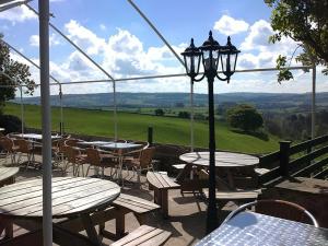 a patio with tables and chairs and a street light at Lathkil Hotel in Bakewell