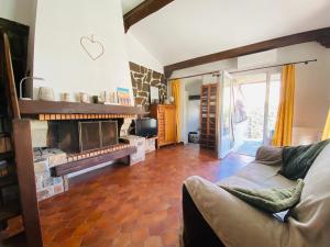 a living room with a couch and a fireplace at Maison proche de la mer in Sainte-Marie-la-Mer