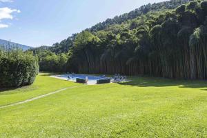 a park with a swimming pool in the grass at Villa Bianca by MMega in Santa Lucia