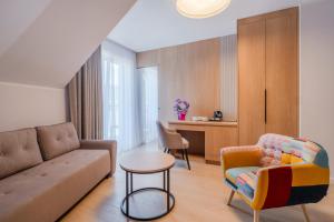 a living room with a couch and a table at Willa Ponikiewka in Międzybrodzie Bialskie