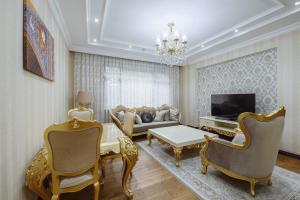 a living room with a couch and a tv at Monday Royal apart hotel in Tashkent