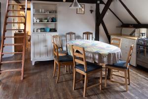 a kitchen with a table and chairs and a ladder at Ekoturystyka Nowina in Nowina