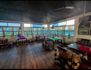 a large room with ping pong tables in it at Paat Halodhiya Farm Stay in Kāhārpāra