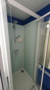a shower with a glass door in a bathroom at Joli studio Hardelot face mer, à 100m du centre-ville! in Hardelot-Plage
