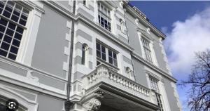 een wit gebouw met een balkon aan de zijkant bij ADAM & EVE Paleisstraat in Den Haag