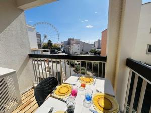 a table with yellow plates and glasses on a balcony at Appt Studio 2 couchages CAP D'AGDE CT121-022 in Cap d'Agde