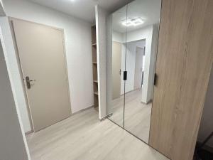 an empty room with a glass door and a hallway at Appt Studio 2 couchages CAP D'AGDE CT121-022 in Cap d'Agde +8 photos