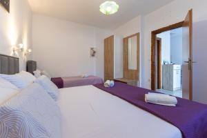1 dormitorio con 1 cama grande con sábanas moradas en Apartments Danka with Shared Pool, en Pula 16 fotos más