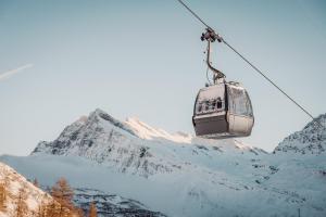 a ski lift in front of a snow covered mountain at Lodge Brocco & Posta in San Bernardino