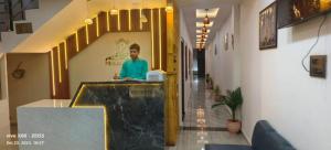 a man standing at a counter in a building at Hotel Prince palace in Ayodhya