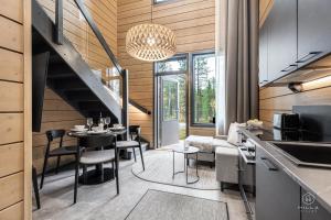 a kitchen and living room with a table and chairs at Levin Lyhty Bea by Hilla Villas in Kittilä