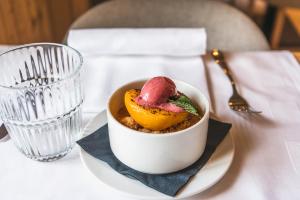 a bowl of food on a table next to a glass at Lodge Brocco & Posta in San Bernardino +24 photos