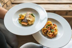 two white plates of food on a table at Lodge Brocco & Posta in San Bernardino