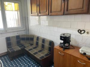 a kitchen with two chairs sitting on top of a counter at Apartament Eric in Craiova