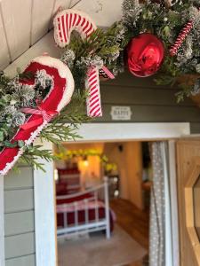 a christmas wreath on the front door of a house at 2 - Floras Cabin- Romantic Escape - Unmissable View in Pont Sticill
