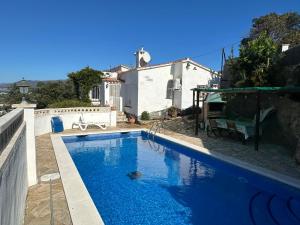 a swimming pool in front of a house at Casa Jazmin in Roses