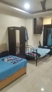 a bedroom with two beds in a room at Lakeside in Mumbai