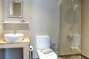 a bathroom with a toilet and a sink and a shower at Kalkan Ayapa Hotel in Kas