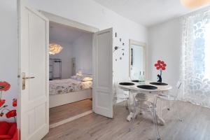 a white room with a table and a bed at Villa Carla in Salò
