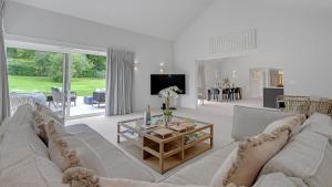 a living room with a couch and a table at Lambs Lawn in Coulston +17 photos