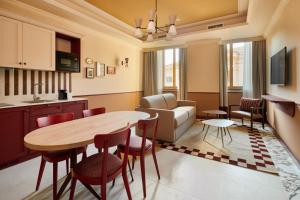 a kitchen and living room with a table and chairs at Homy Livia Verona in Verona
