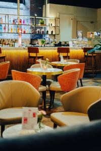 a restaurant with tables and chairs and a counter at Ropewalks Hotel in Liverpool