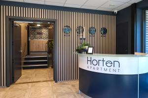 a hotel entrance with a sign on the wall at Horten Apartment in Horten