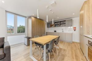 a kitchen and dining room with a table and chairs at Brand New Ensuites In Central Leeds in Leeds