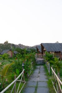 a walkway leading to a house in a resort at The Sundown Hampi in New Hampi