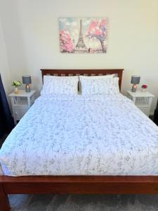 a bedroom with a bed with a blue bedspread at Renovated Entire 2BR Flat, Comfort, Scenic Views, Free Parking & 10 min to Ferry in Wellington +51 photos