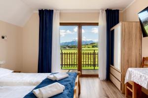 En eller flere senge i et værelse på Willa u Polczyków