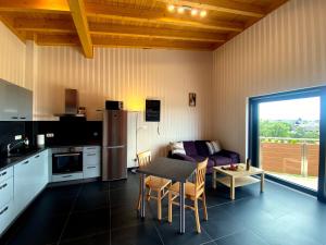 a kitchen and living room with a table and a couch at Ferienwohnung Am Weiher Wohnung 6 Für 2 Personen in Nideggen