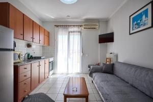 a living room with a couch and a table at ChioSmart Kontari Apartments in Chios