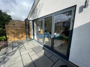 a patio with sliding glass doors on a house at The Townhouse Collection 2BR Close To City Centre in Cardiff