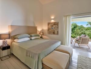 a bedroom with a large bed and a patio at Cascioni Eco Retreat in Arzachena +117 photos