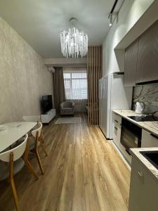 a kitchen with a table and a dining room at Prestige Ap in Ustʼ-Kamenogorsk