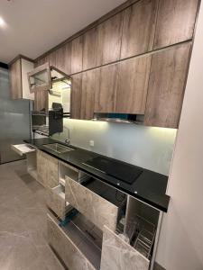 a bathroom with a sink and a mirror at H-Vista Suites - The Wisteria 