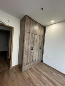 a large wooden cabinet in a room with wood floors at H-Vista Suites - The Wisteria 