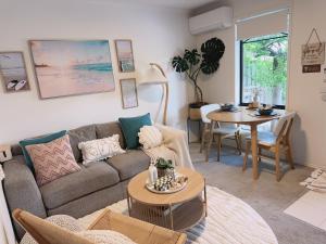 a living room with a couch and a table at Bentleigh Private 1BR 5min Train Cafes Quiet Cozy in Melbourne