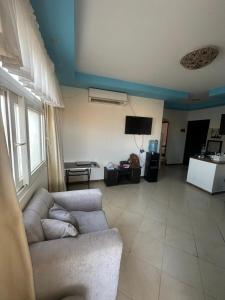 a living room with a couch and a tv at Sea Breeze Apartment Sharm el-Sheikh in Sharm El Sheikh