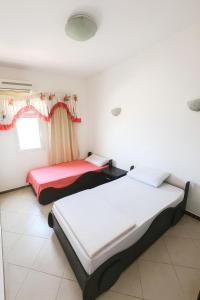 a bedroom with two beds in a room at Sea Breeze Apartment Sharm el-Sheikh in Sharm El Sheikh