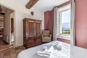 a bedroom with a bed and a large window at Le Lieutenant in Bonnieux +9 photos